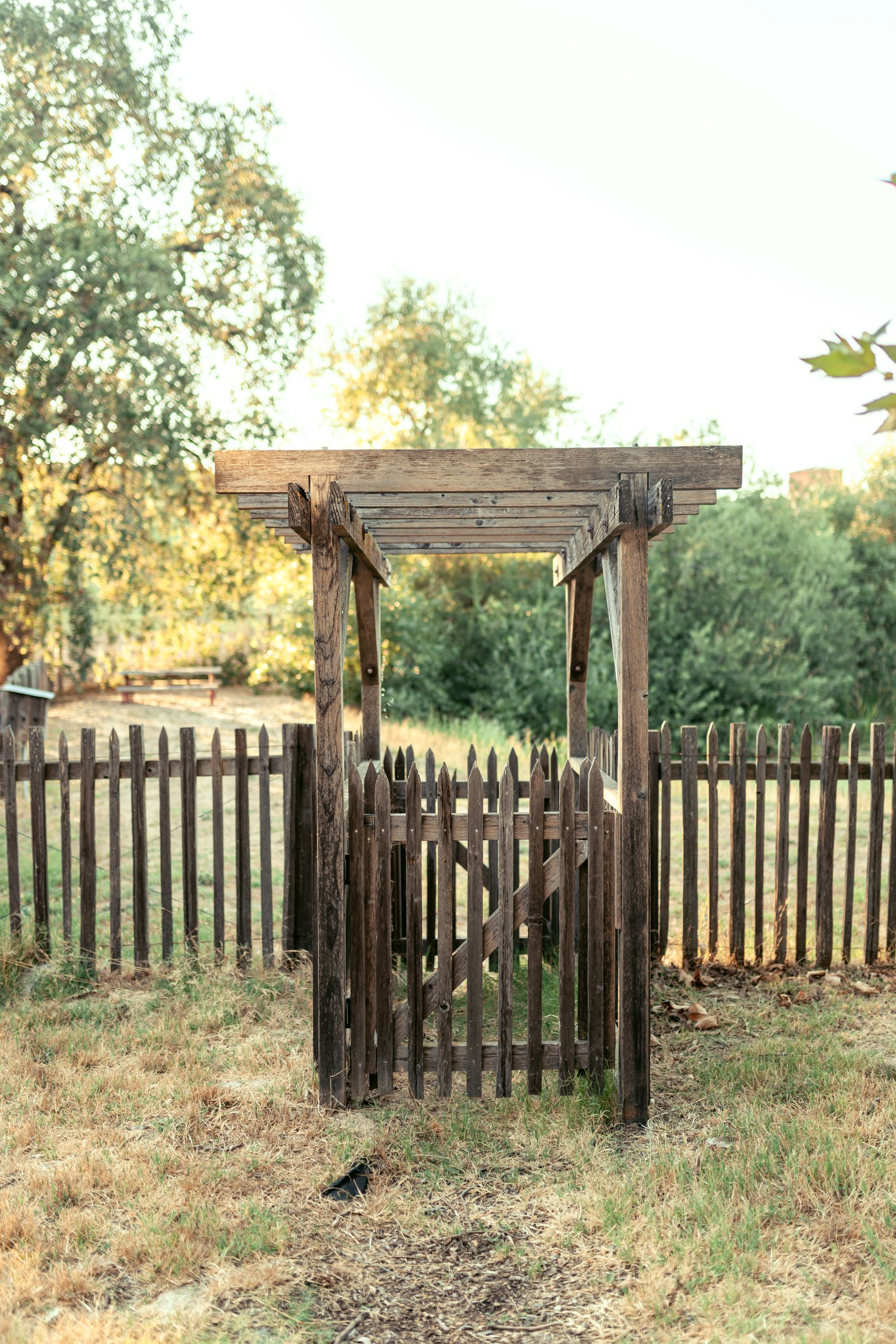 Wooden outdoor fence surrounded by greenery
