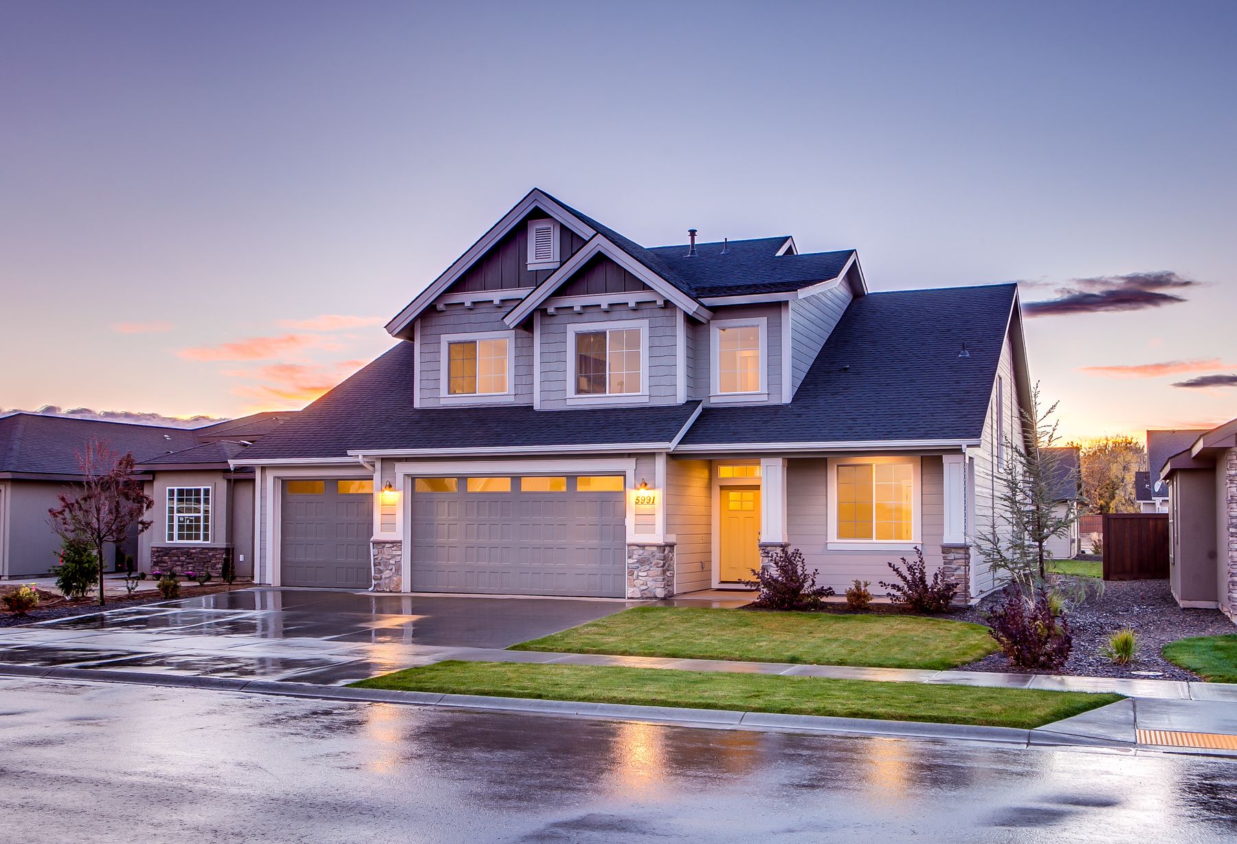 Blue-gray American house with a front porch at twilight